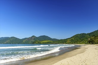 The sea and the beach next to the mountains and forest of Bonete beach on the island of Ilhabela,