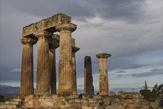 Archaic Temple of Apollo, Doric Columns, Ancient Greek columns stand tall under a dramatic evening