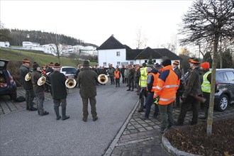 Hunters and hunting assistants, so-called beaters, in front of the start of the hunt, address by