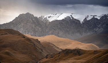 Dramatic mountain landscape with yellow meadows, mountain peaks, Keltan Mountains, Sary Beles