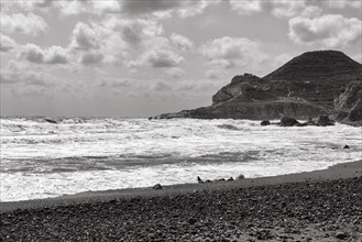 Surf on pebble beach, rocky coast, monochrome, Cabo de Gata Natural Park, Las Negras, Almeria,