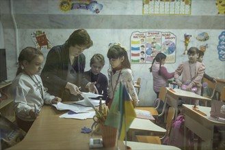 Pupils in a classroom in one of the metro schools in Kharkiv. Classrooms were set up in various