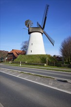 Windmill Hummelbecker Mühle under a cloudless blue sky, a Wall-Holländer, is part of the