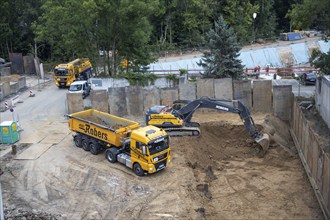 Construction work, excavating a building pit for a residential building