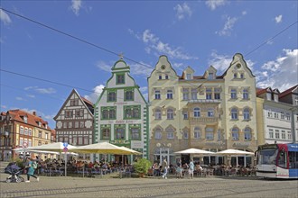 Historic restaurant Hofbräu am Dom with green tail gable, houses and tram, green, street