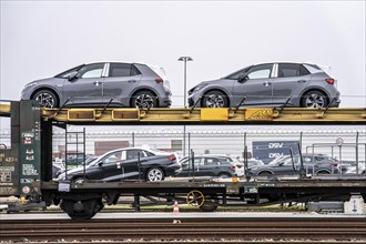 Freight train, car transporter brings new cars from Germany, for export by ship, to the port of