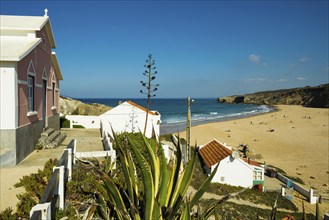 Colourful holiday homes and beach, Monte Clérigo, Atlantic coast, Algarve, Portugal, Europe