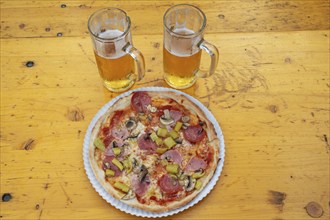 Pizza and two beers on a beer table at a party Italian night in Sylbacxh, Lower Franconia, Bavaria,