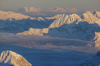 Mountain peak above high fog, evening light, winter, view from Zugspitze to Karwendel Mountains,