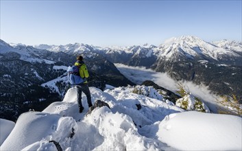 Mountaineers on the snowy summit of the Jenner in autumn, view of the sea of clouds and the