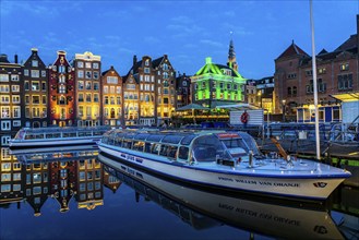 Canal houses on the Damrak, in the centre of the old town of Amsterdam, harbour, starting point of