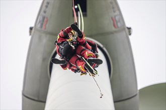 Height rescuers from the Gelsenkirchen fire brigade practise abseiling from a wind turbine from a