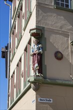 Figure, statue of a chic lady at a town house and former department stores' Josef Boss in the