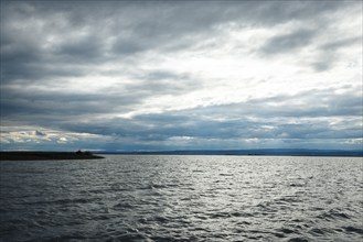 Wide expanse of water with dramatic sky, k Lake Neusiedl, Burgenland, Austria, Europe