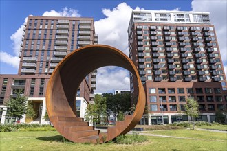 Walk-in steel sculpture on Maashaven Noordzijde Street, new high-rise residential buildings in the