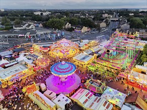 View from above from the Ferris wheel of the Cranger Kirmes in the evening and the district of the