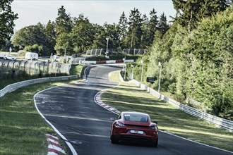 View from the perspective of racing driver on sports car Porsche Cayman driving on Nürburgring race