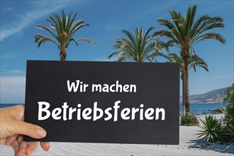 Symbolic image company holidays: Sign with the inscription WIR MACHEN BETRIEBSFERIEN in front of