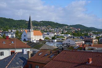 City of Molde with cathedral church and houses as well as mountains and sky in the background,