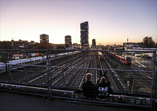 Chilling out at sunset on the Modersohn Bridge, view of railway tracks, trains and the 140 metre