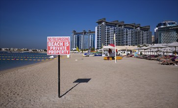 Private beach sign, NO TRESPASSING, BEACH IS PRIVATE PROPERTY, beach, parasols, Hotel NH Collection