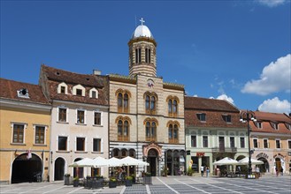 Historic architecture under a clear blue sky, cafés with parasols on the market square, Church of