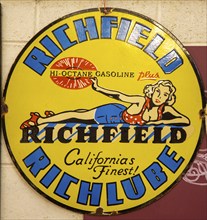 Vintage metal sign for Richfield Hi-Octane gasoline, Richlube, from California, USA, blonde woman