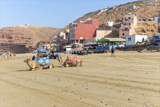 Sandy beach and buildings, Legzira, southern Morocco, north Africa