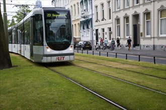 Tram tracks running over grass surface through city streets Rotterdam, Netherlands