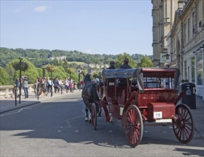 Horse drawn carriage tourist ride on Grand Parade, Bath, Somerset, England, United Kingdom, Europe