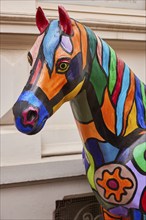 Head of a colourful horse sculpture in the style of Pop Art in the city of horses Warendorf,