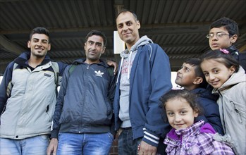 Syrian refugees arrive at Schönefeld station on a special train. They are then taken by bus to