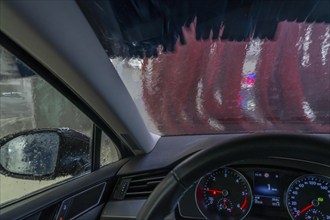 Car in an automatic car wash, car wash tunnel