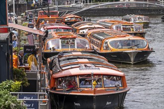 Canal cruises, pier of Lovers Canal Cruises, at Amsterdam Centraal station, Amsterdam Netherlands