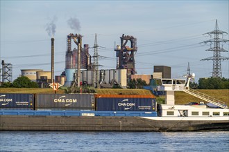 Industrial backdrop of the ThyssenKrupp Steel steelworks in Bruckhausen, on the Rhine, cargo ship,