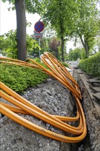 Laying of fibre optic cables, empty conduits are laid under a pavement, in which the actual fibre