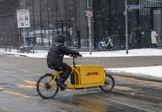 Winter in Frankfurt, DHL bicycle courier in the banking district, Hesse, Germany, Europe