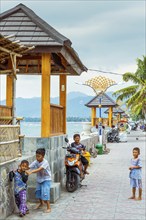 Children playing on the promenade in Bangsal, street, street scene, urban, fun, joy, childhood,