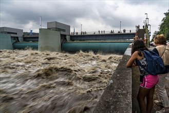 Weir of the Lake Baldeney in Essen, the masses of water roar through the open weirs, high water on