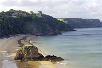 Long sandy beach with rocks and cliffs in the evening light, Tenby, Pembrokeshire, Wales, Great