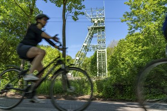 Cycling along the Ruhr, on Lake Baldeney in Essen, headframe of the former Carl Funke colliery,