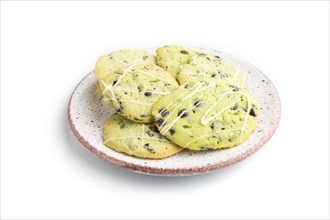 Green cookies with chocolate and mint on ceramic plate isolated on white background. side view,