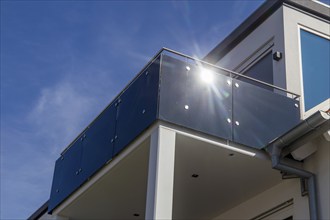 Black balcony railing made of glass and stainless steel