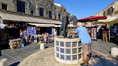 Martyrs Square, market square with seahorse fountain and shops in the background, sunny day with