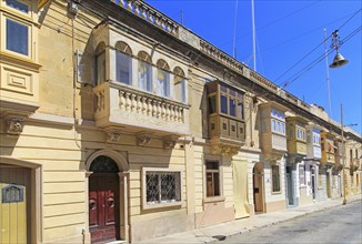 Balconies of houses historic street in Tarxien area, near Valletta, Malta, Europe