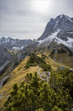 Mountaineers on a hiking trail on the ridge of Hahnkampl, mountain panorama with rocky steep peaks,