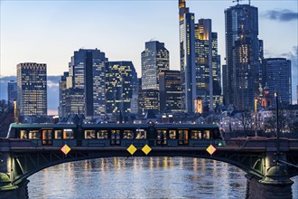 Skyline of the city centre of Frankfurt am Main, river Main, dusk, Ignatz-Bubis-Brücke, tram,