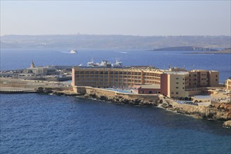 View of hotel and ferry terminal towards Gozo Channel, Cirkewwa, Republic of Malta