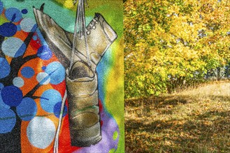 Graffito with hiking boots and trees with autumn foliage, Wiesenburg, International Art Trail,