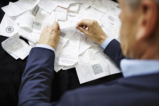 The subject of taxes. A man holds receipts in his hand in Berlin, 09/08/2024